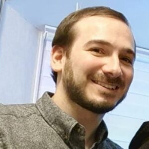 A headshot of Mike smiling at the camera